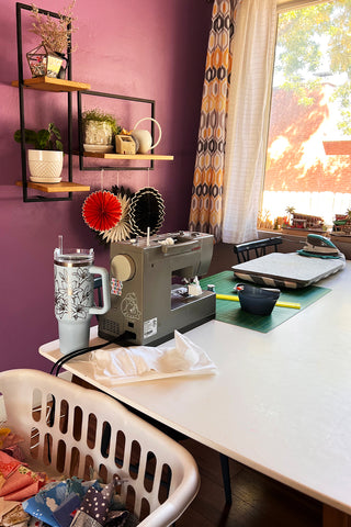 Sewing station setup for scrappy quilt as you go at a kitchen table
