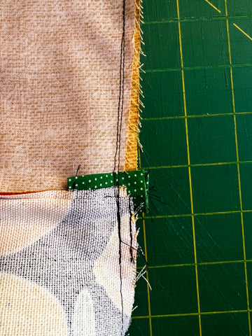 Photo displays resewing a seam that wasn't quite right.