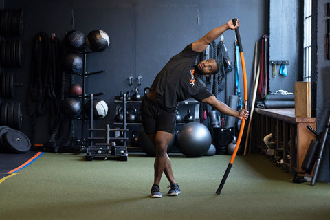 Ray Bailey stick mobility bow and arrow stretch in gym