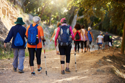 group of older people hiking in nature