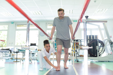 man in physical therpay improving walking