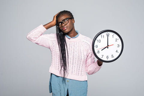 woman with clock frustrated with time