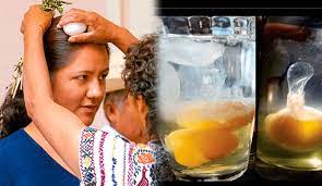 Curandera cleansing a person by rubbing an egg over their head. Separate image of a cracked egg in a glass.