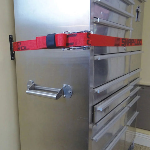 Cargo strap holding a metal tool chest in place