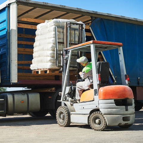Forklift loading cargo in a truck