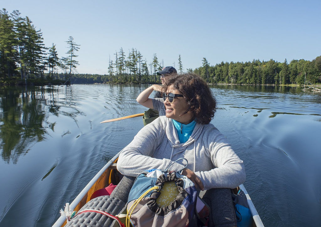two people in a canoe on an adirondack lake