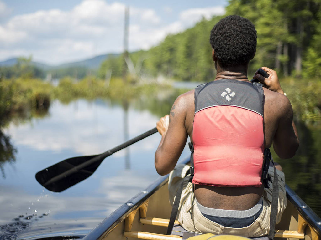 a photo of a person paddling in a canoe