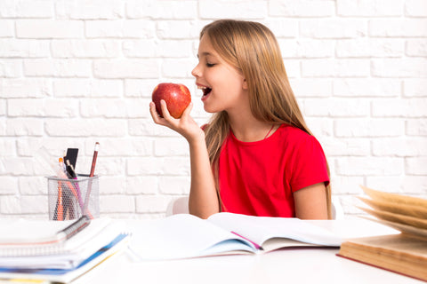 playful-schoolgirl-biting-apple