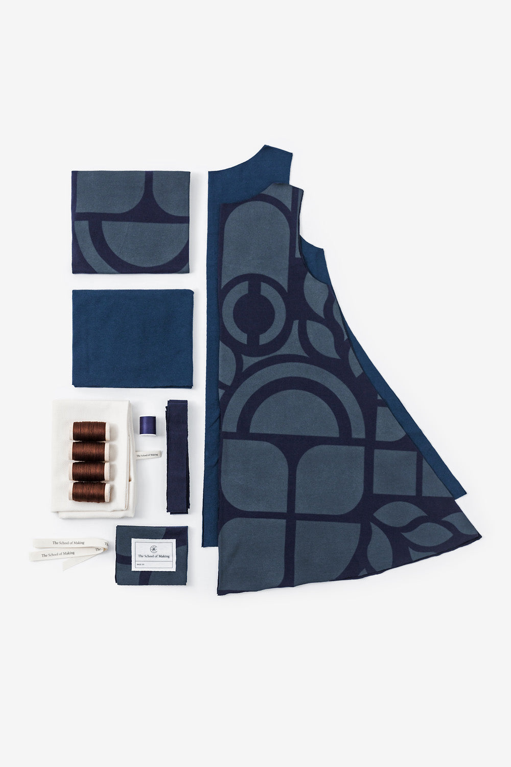 The School of Making A-Line Tunic Kit in Navy and Peacock with Abstract Stencil. Image shows kit contents, including pre-cut fabric, thread, and embroidery floss.