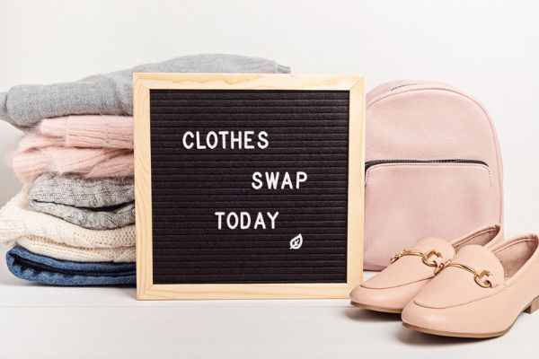 how to stop buying clothes - image of a clothes swap