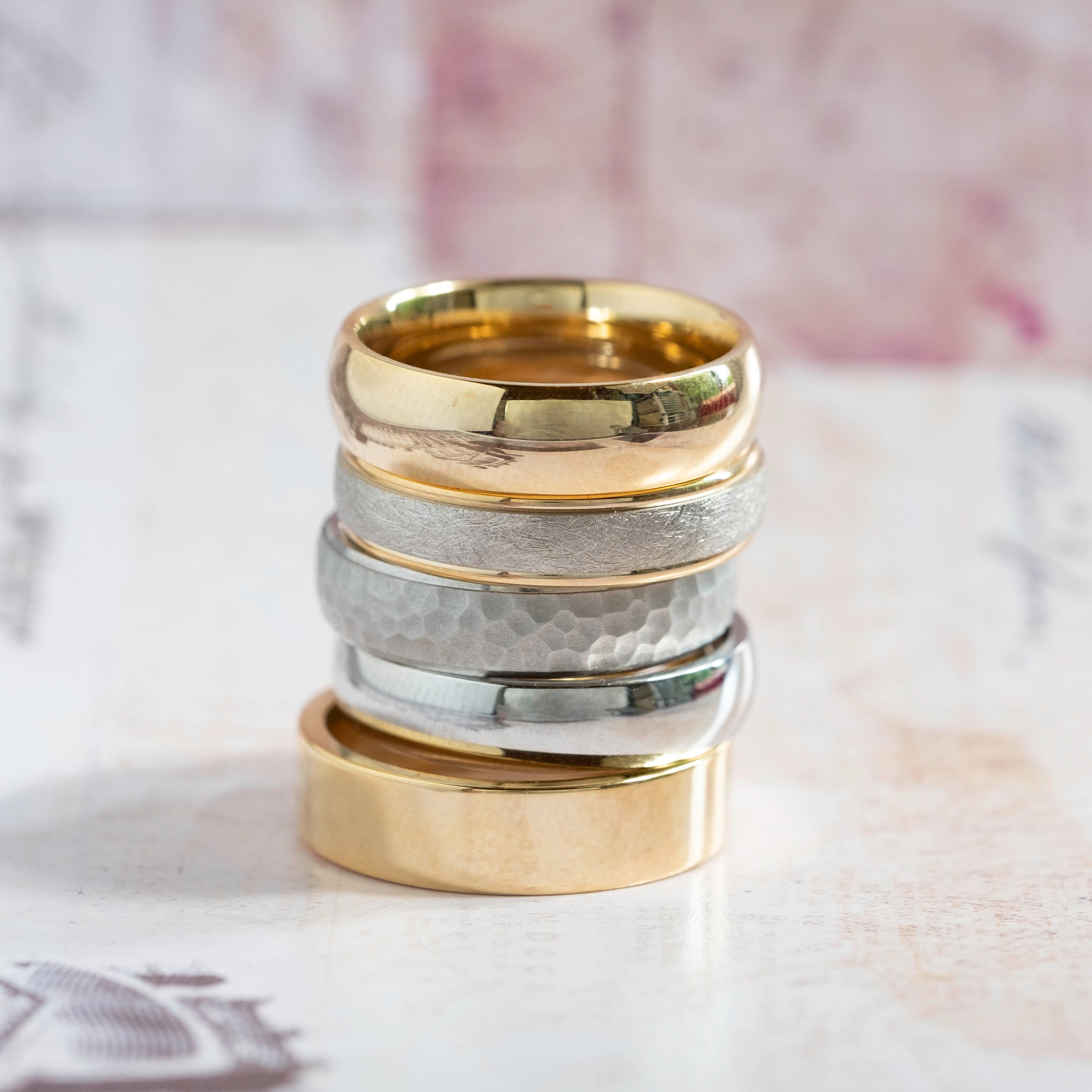 Stack of men's white and yellow gold wedding rings