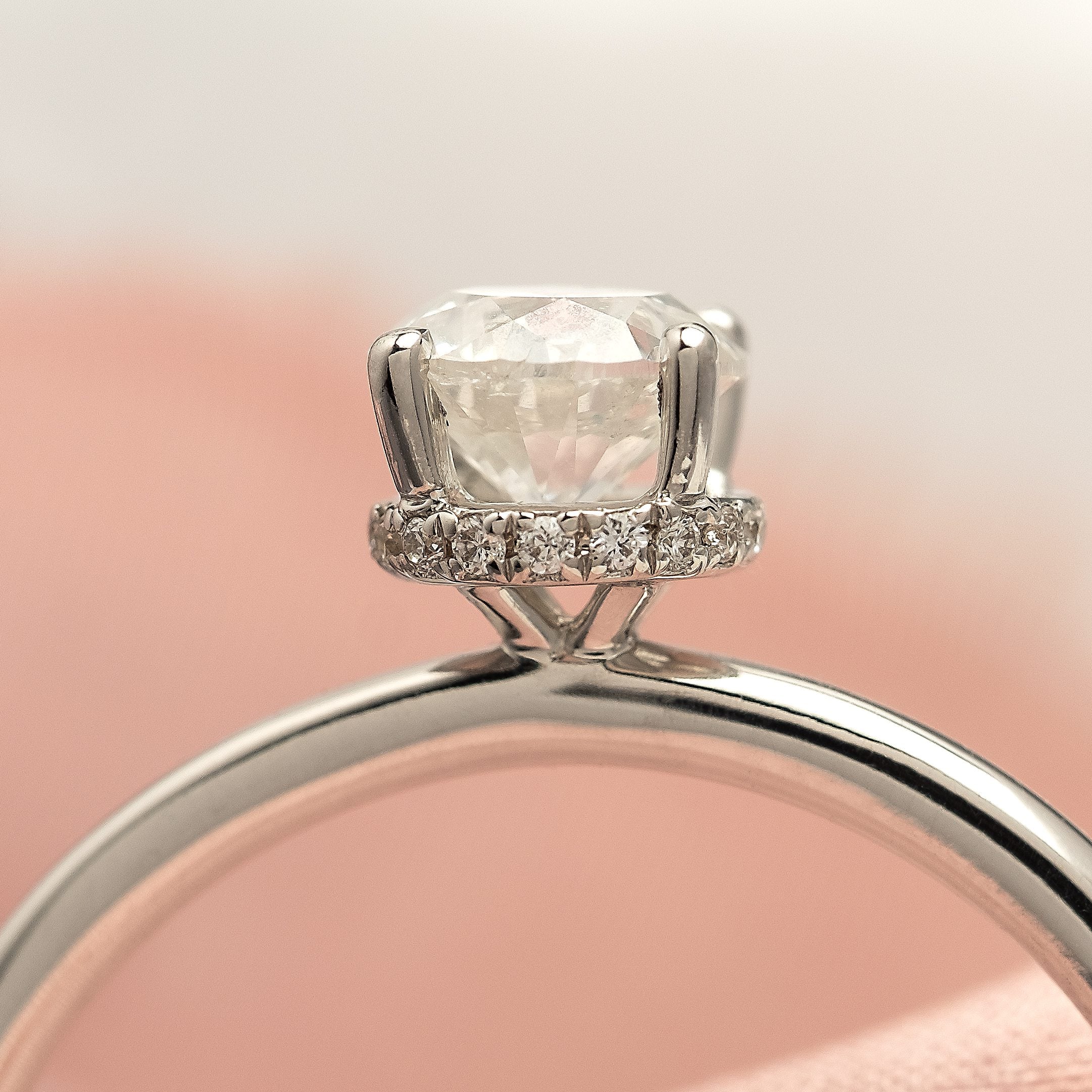 Solitaire diamond ring with a hidden diamond halo