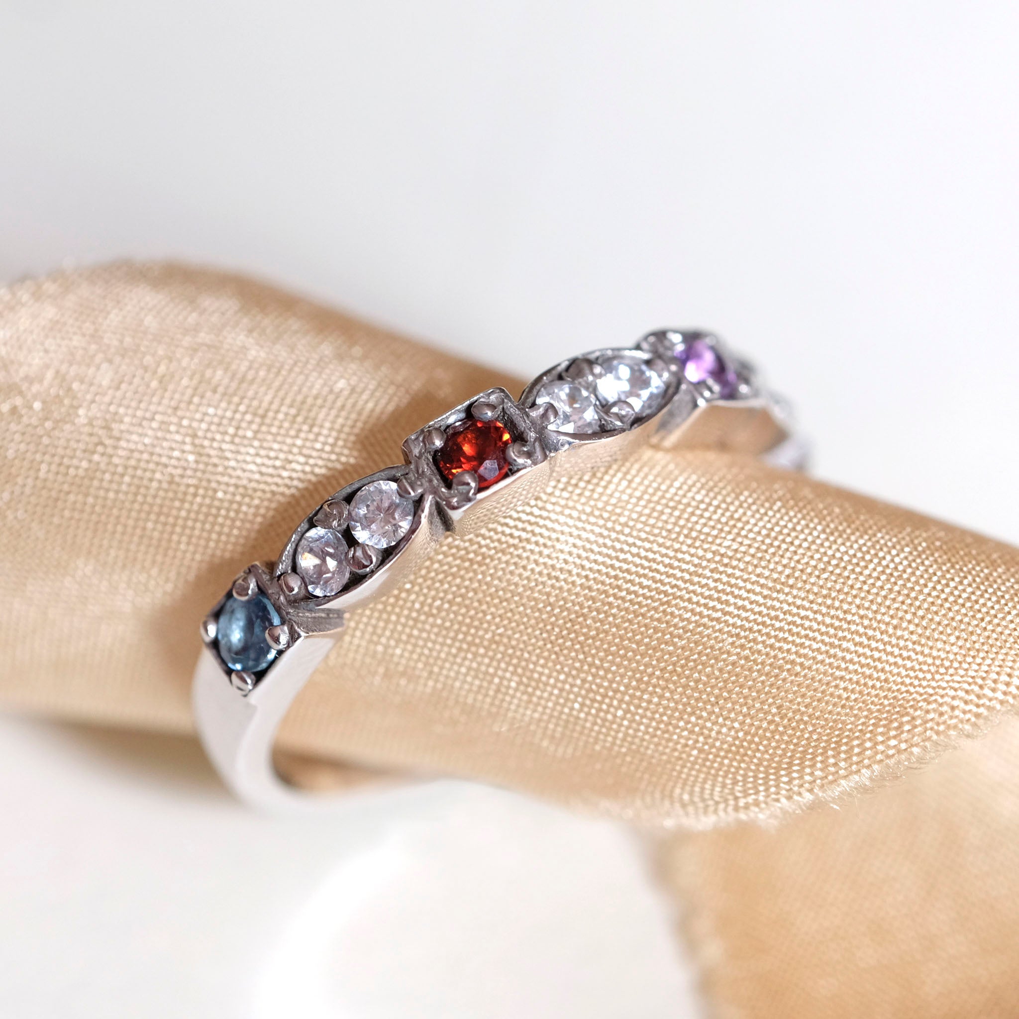 Birthstone ring including diamonds, ruby and aquamarine