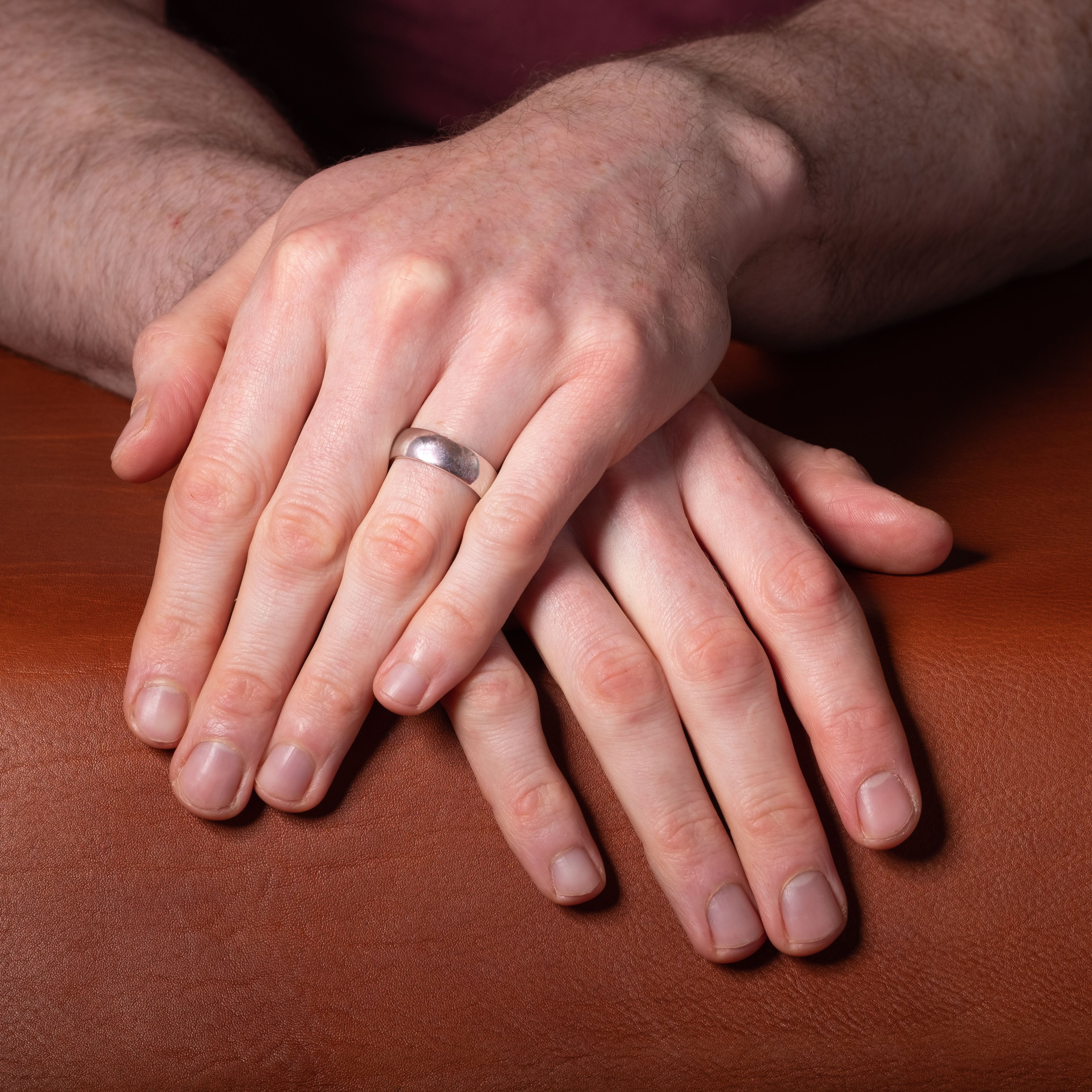 White gold wedding ring shown on man's hand