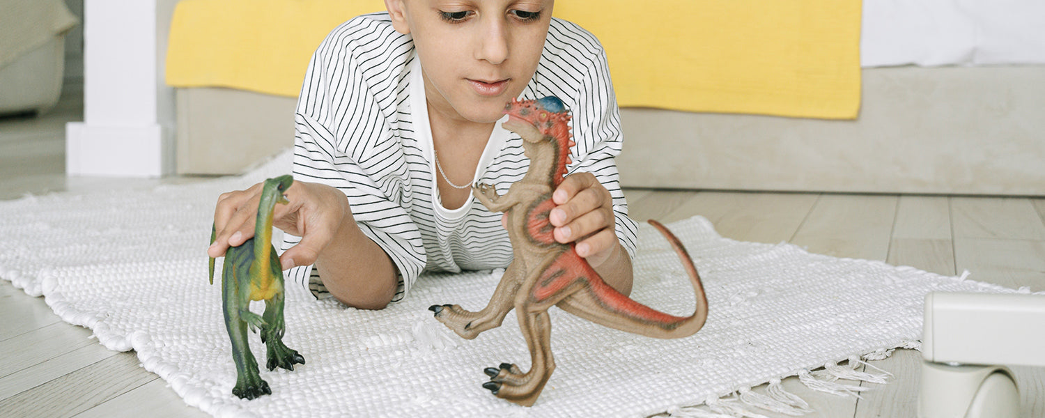 A child playing with dinosaur toys