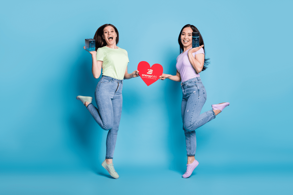 two women jumping with heart