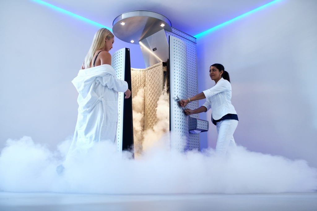 woman going into cryotherapy chamber 