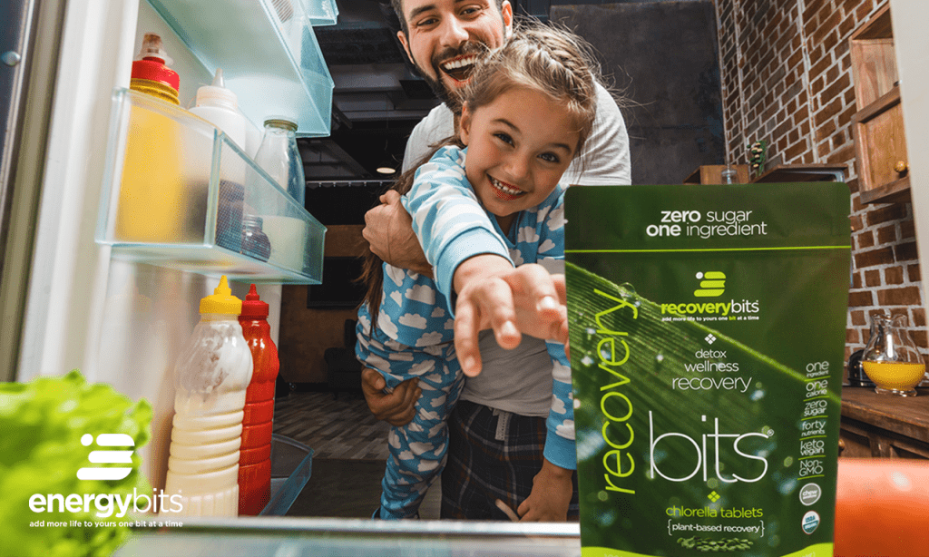 Father and little girl grabbing a bag of RECOVERYbits from the fridge. 
