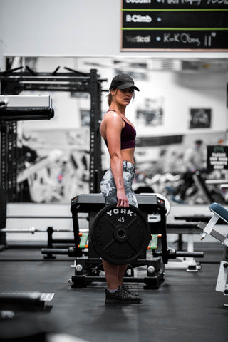 A woman standing in the gym 