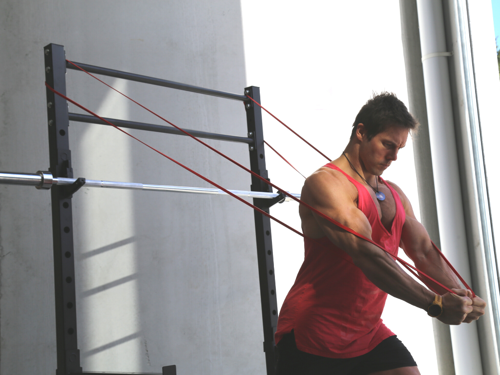 Aaron Curtis showing off his personal trainer skills with the Red Resistance Band and our 60X60 Power Rack. 