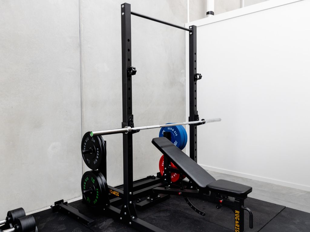 Rack, bench, bar and coloured Olympic bumper plate set. 
