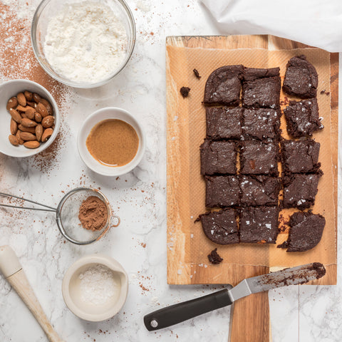 brownies on a wooden tray with ingredients on the side