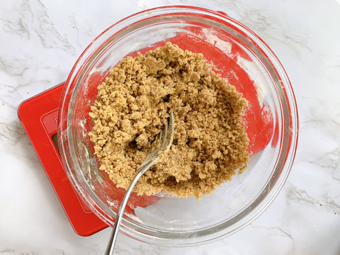 cookie mix in a clear bowl on a red scale