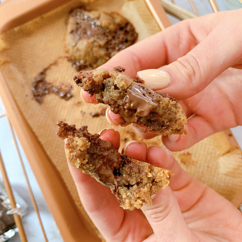 hands holding freshly baked dairy free cookie