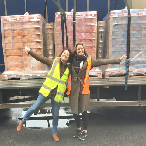 charlotte and kim and a big lorry full of boxes of cookies 