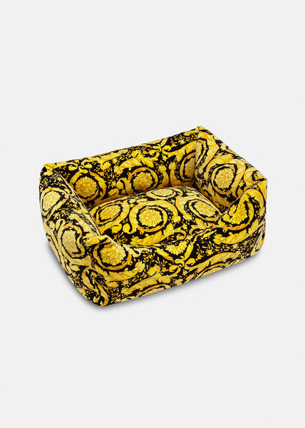 A black and gold Versace dog bed.  