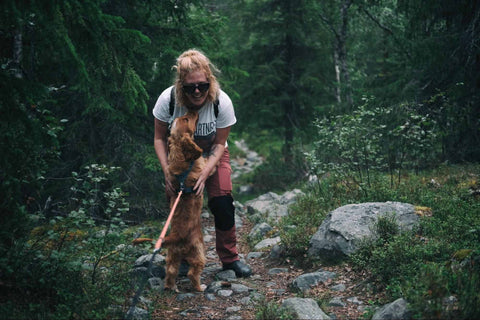 a girl hiking with her dog