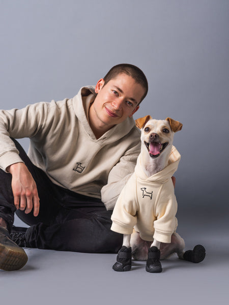 small white dog wearing our RIFRUF essential dog hoodie