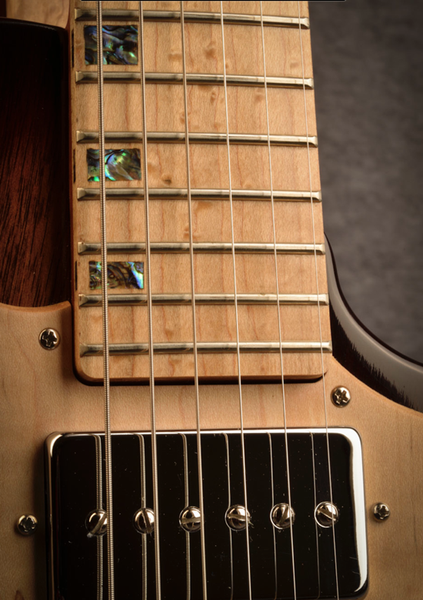 Fretboard inlay on maple guitar