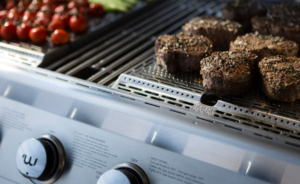 burger patties grilling on gas grill burner