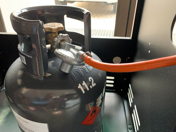 liquid propane tank under a gas grill