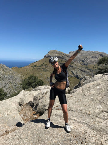 Women cyclist on top of a mountain