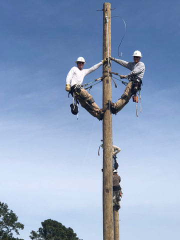 Ethan Reece and classmate climb electric utility pole