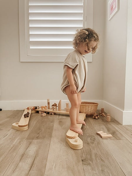 toddler on the wooden balance beam