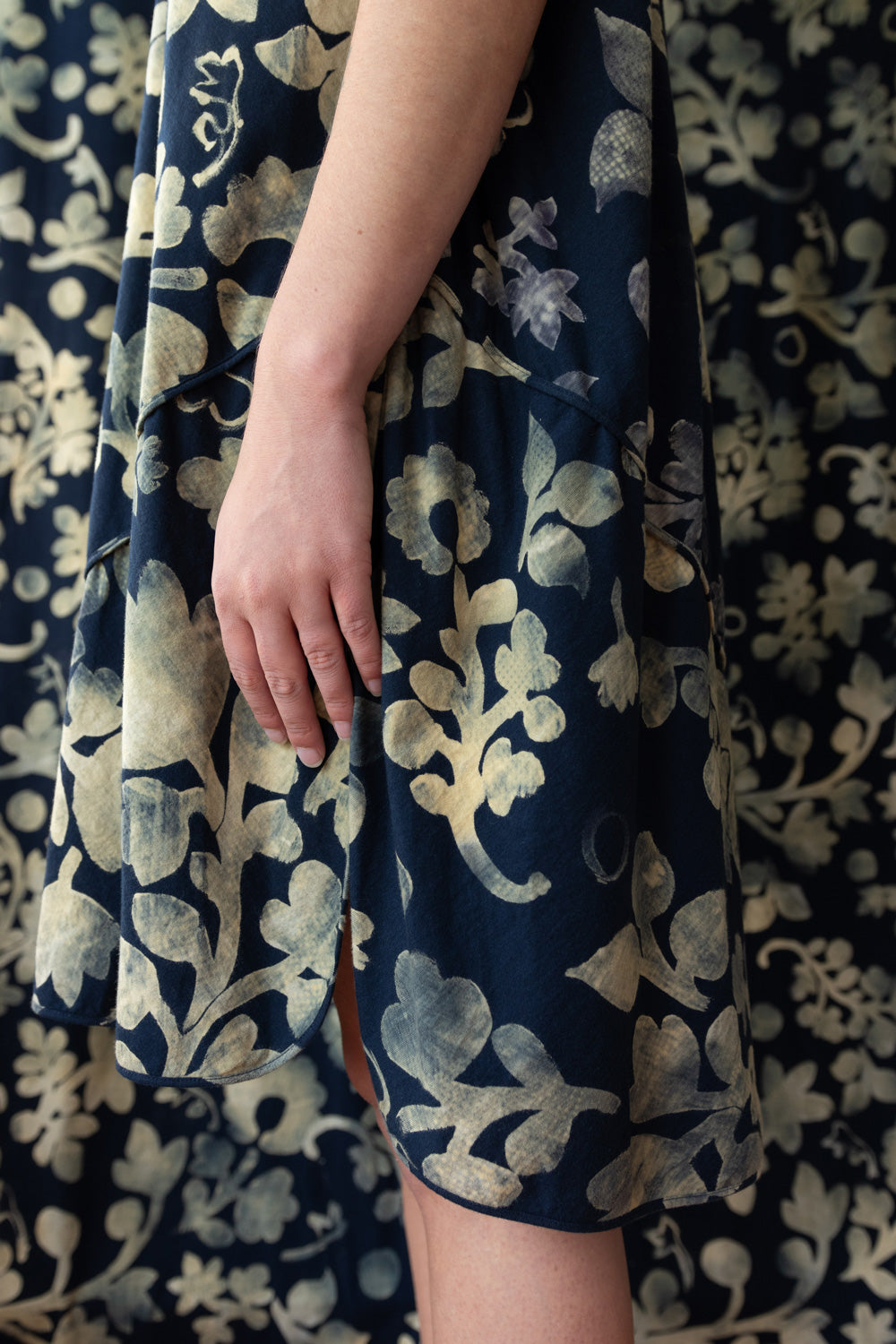 Model wearing The Spencer Dress in Navy with floral painted design.