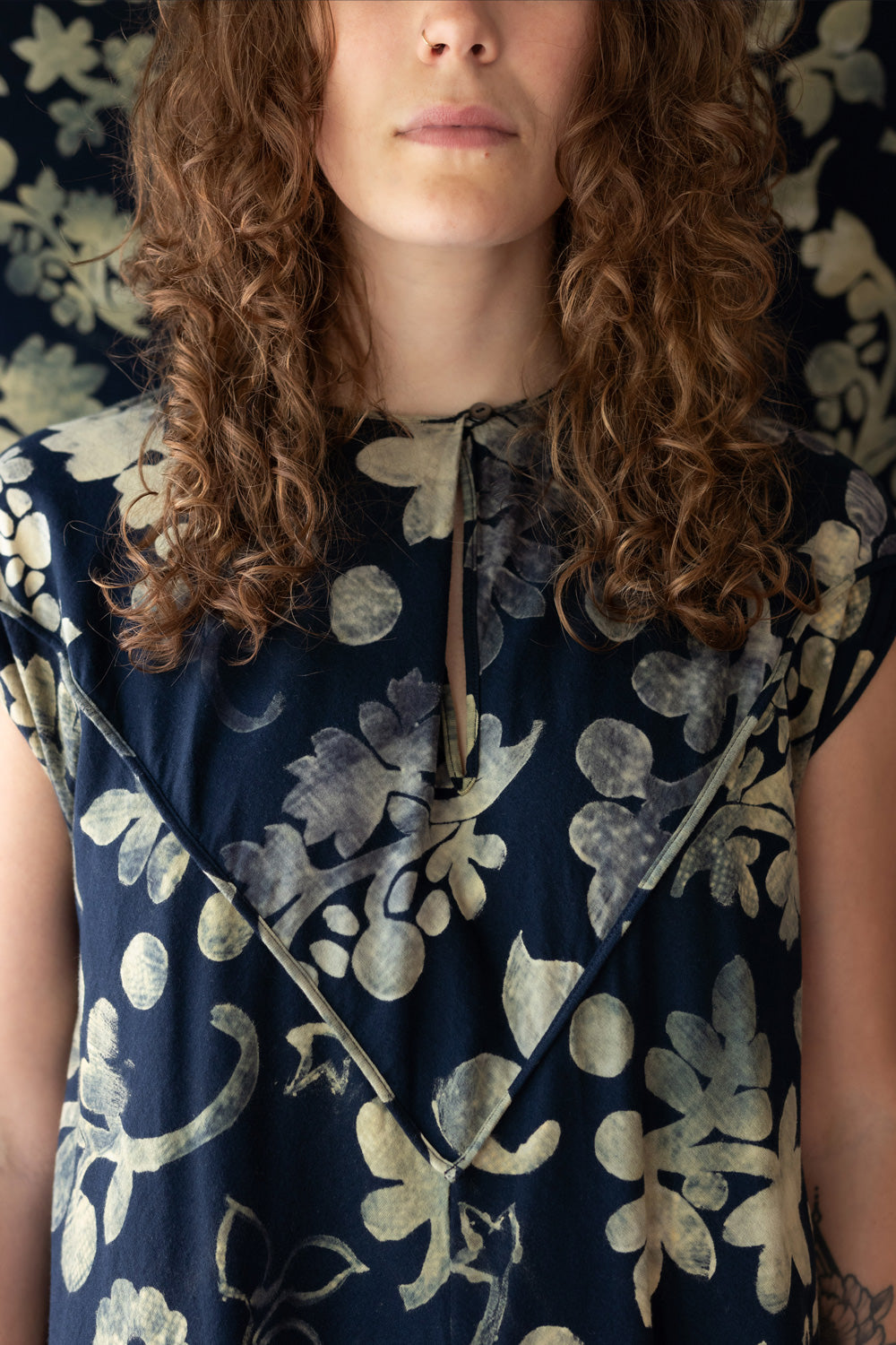 Model wearing The Spencer Dress in Navy with floral painted design.