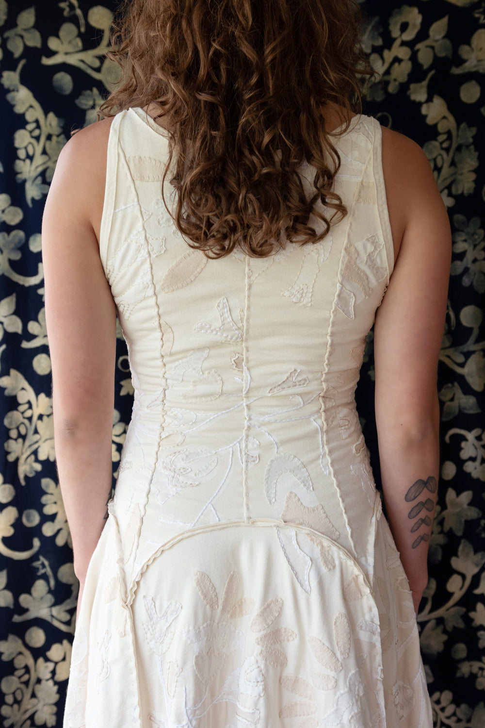 Back view of model wearing the Tenby Dress in natural.