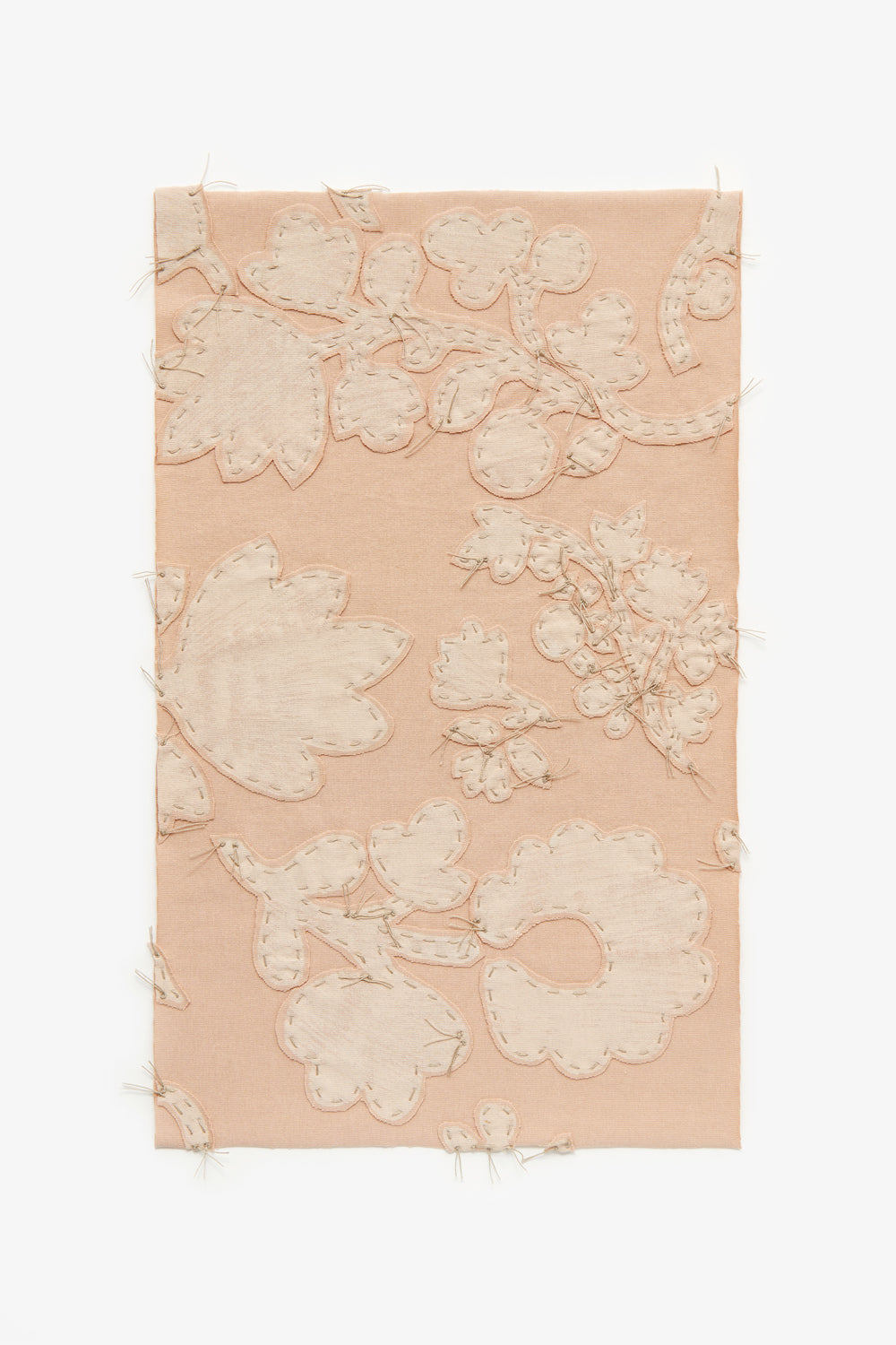 Swatch featuring hand-sewn floral appliqué on vetiver pink fabric.