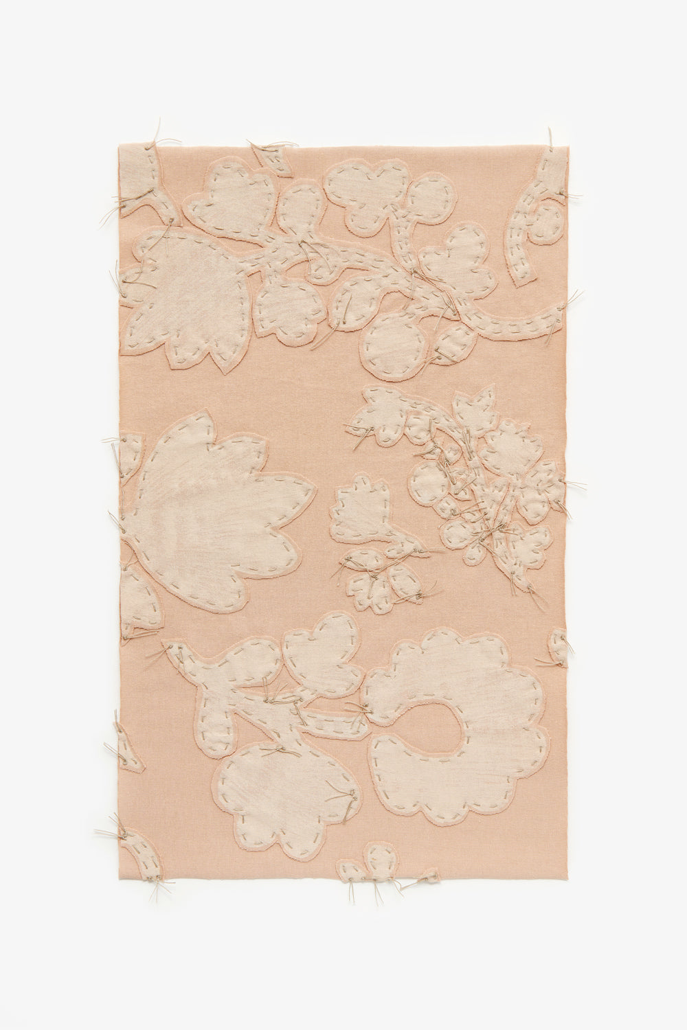 Swatch featuring floral appliqué and embroidery on vetiver pink fabric.
