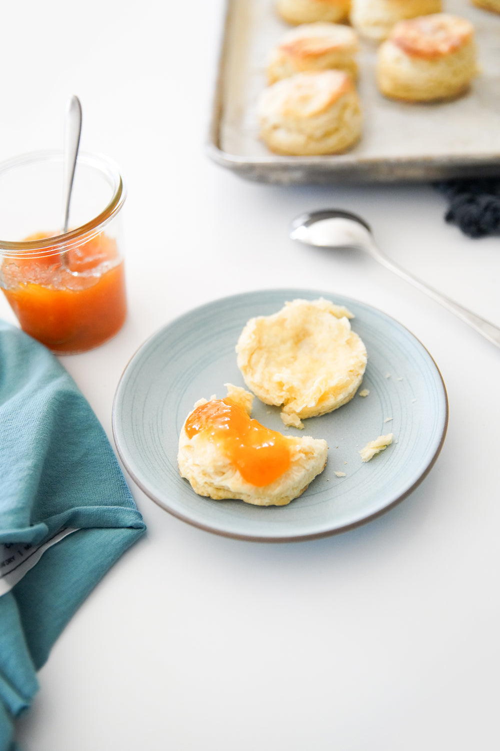 Heath Ceramics Etched Salad Place in Limited Edition Wave Blue Color styled with a biscuit and tea towel in wave.  