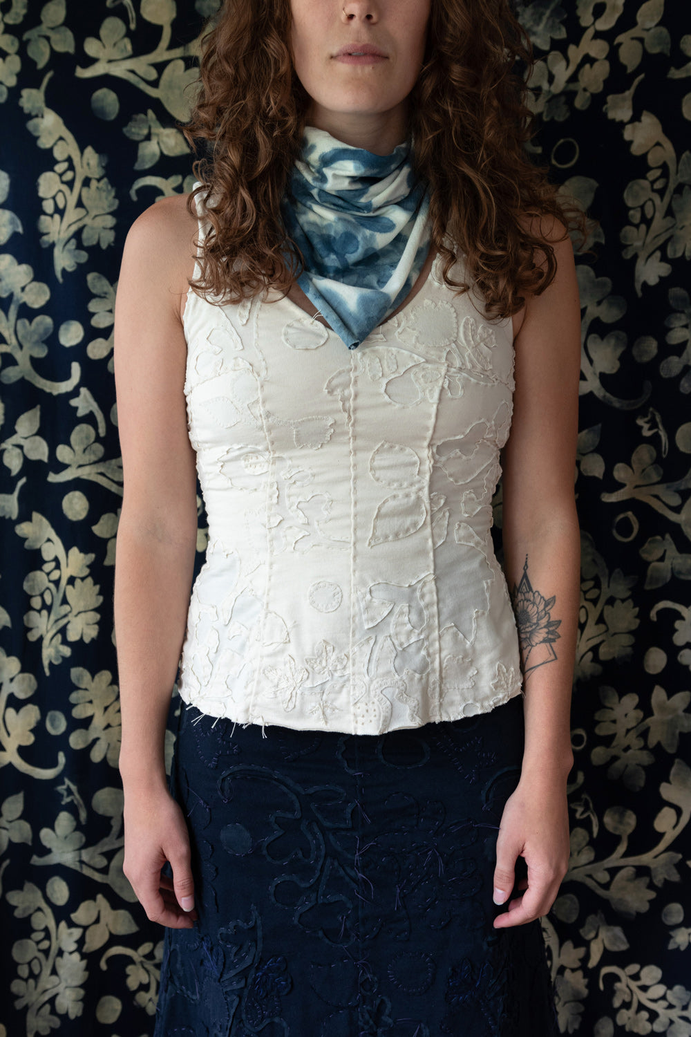 The Haven Top in hand-sewn organic cotton with floral appliqué and embroidery. Shown on model in Natural colorway.