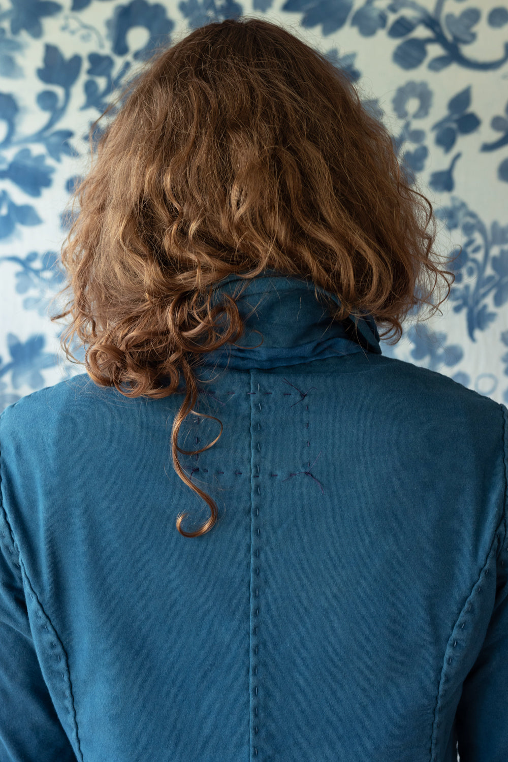 The back side of the Indigo Peacoat in Midnight color, shown on model.