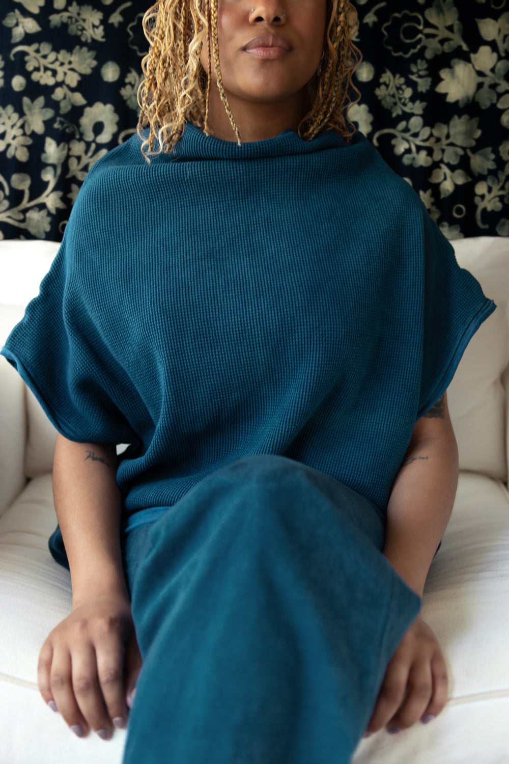 Model wearing the sleeveless Waffle Sweatshirt in dark indigo. Made with 100% organic cotton.