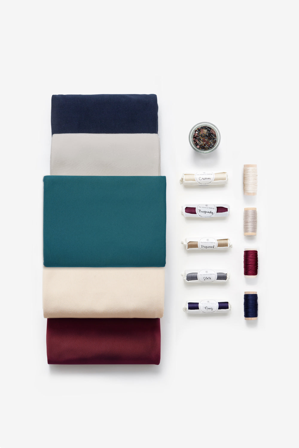 Studio Bundle with Teal, Sand, Beige, Navy, and Plum fabric, plus beads, thread, and floss.