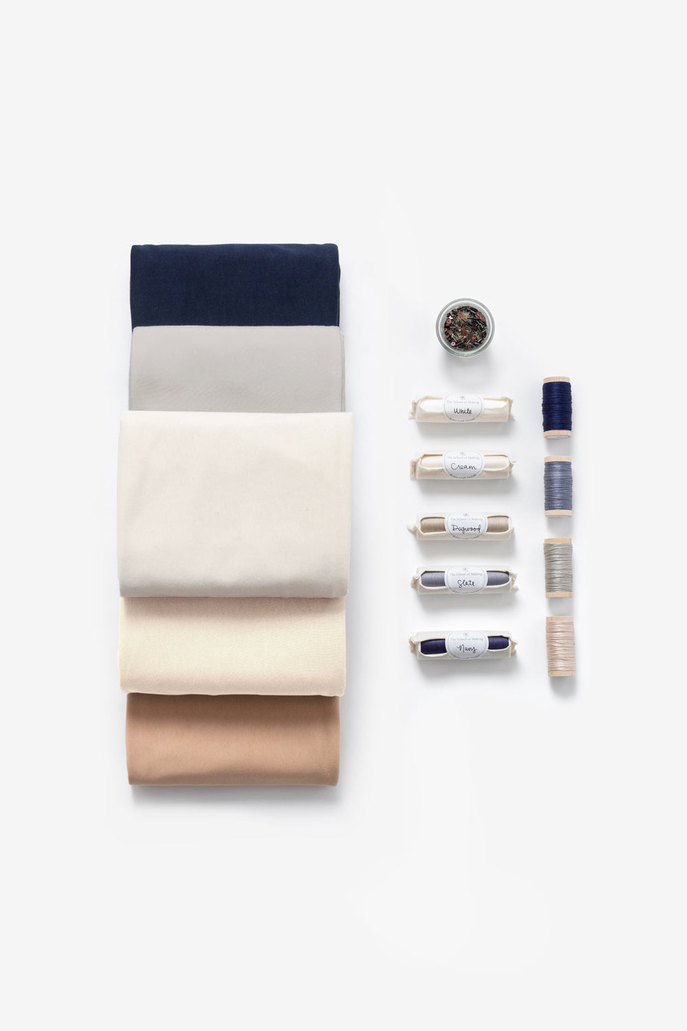 Fabric bundles in Navy, Sand, Natural, Beige, and Ballet, plus beads, thread, and floss.