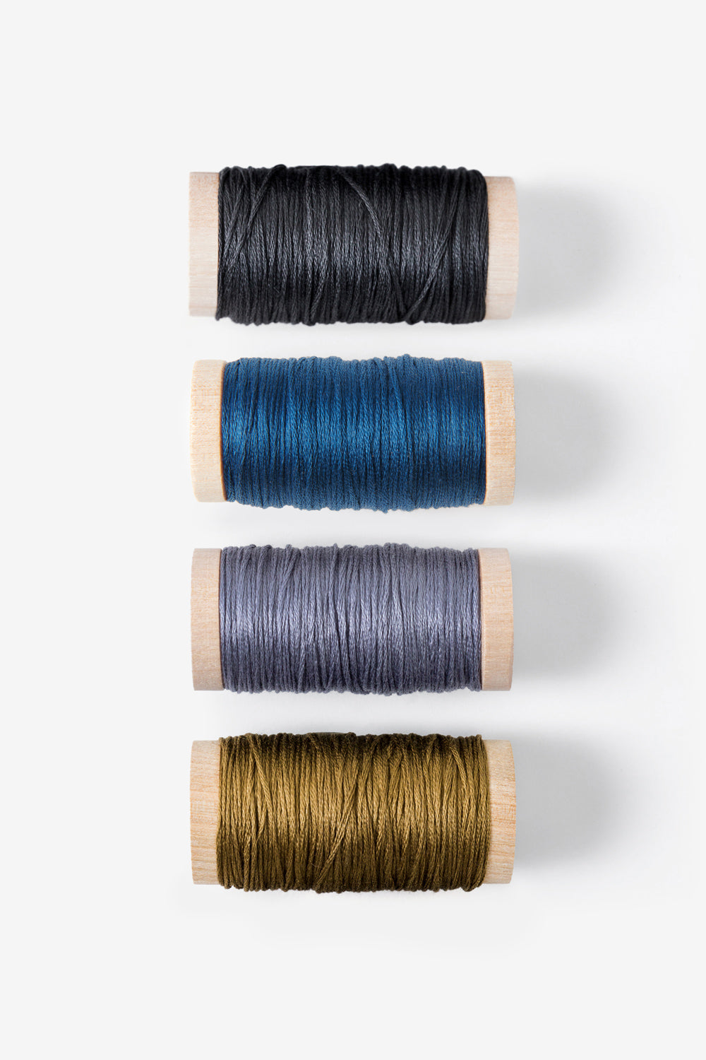 Embroidery Floss in Charcoal, Peacock, Slate, and Ochre.